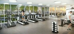 Surrey apartment for rent - A woman is running on a treadmill in a brightly lit gym.