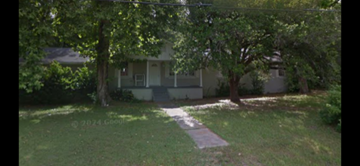 Grand Bay house for rent - A house with a tree in front of it.