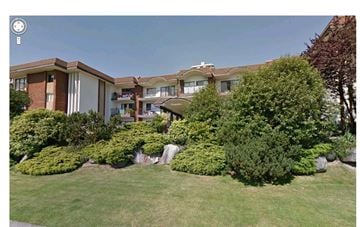 North Vancouver apartment for rent - A building with a green lawn in front.