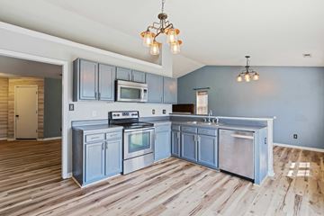 Richlands house for rent - A kitchen with wooden floors and a large island.