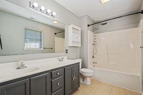 Richlands house for rent - A bathroom with a white sink, a toilet, and a bathtub.