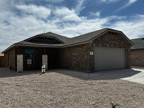 Odessa house for rent - a brick building with a garage and a gravel driveway