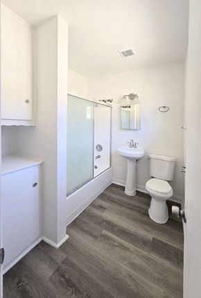 Anaheim apartment for rent - A bathroom with a toilet, sink, and shower.
