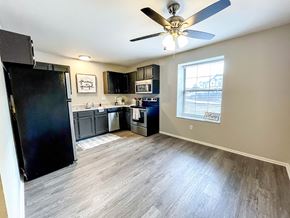Arnold apartment for rent - a kitchen with black appliances and a ceiling fan