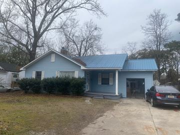 Mobile house for rent - A blue house with a car parked in front.