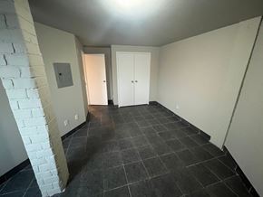 Brantford apartment for rent - A room with a white brick wall and a white door.