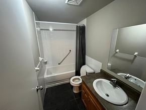 Brantford apartment for rent - A bathroom with a toilet, sink, and shower.
