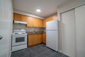 Kitchener apartment for rent - A kitchen with a white refrigerator, white oven, and white stove.