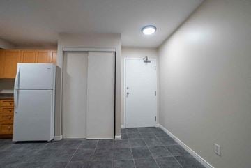 Kitchener apartment for rent - A kitchen with a white refrigerator and a white door.