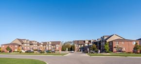 Cambridge apartment for rent - A large building complex with multiple buildings and a parking lot in front.