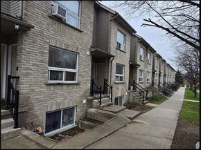 Kitchener apartment for rent - A row of houses with a sidewalk in front.