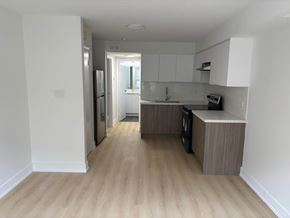 Kitchener apartment for rent - A kitchen with a refrigerator, oven, and sink.
