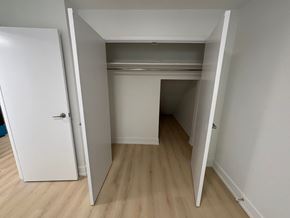 Kitchener apartment for rent - A white door is open to a room with a white ceiling and a white wall.