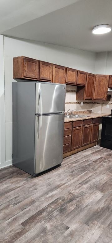 Clinton house for rent - a kitchen with a stainless steel refrigerator and wooden cabinets