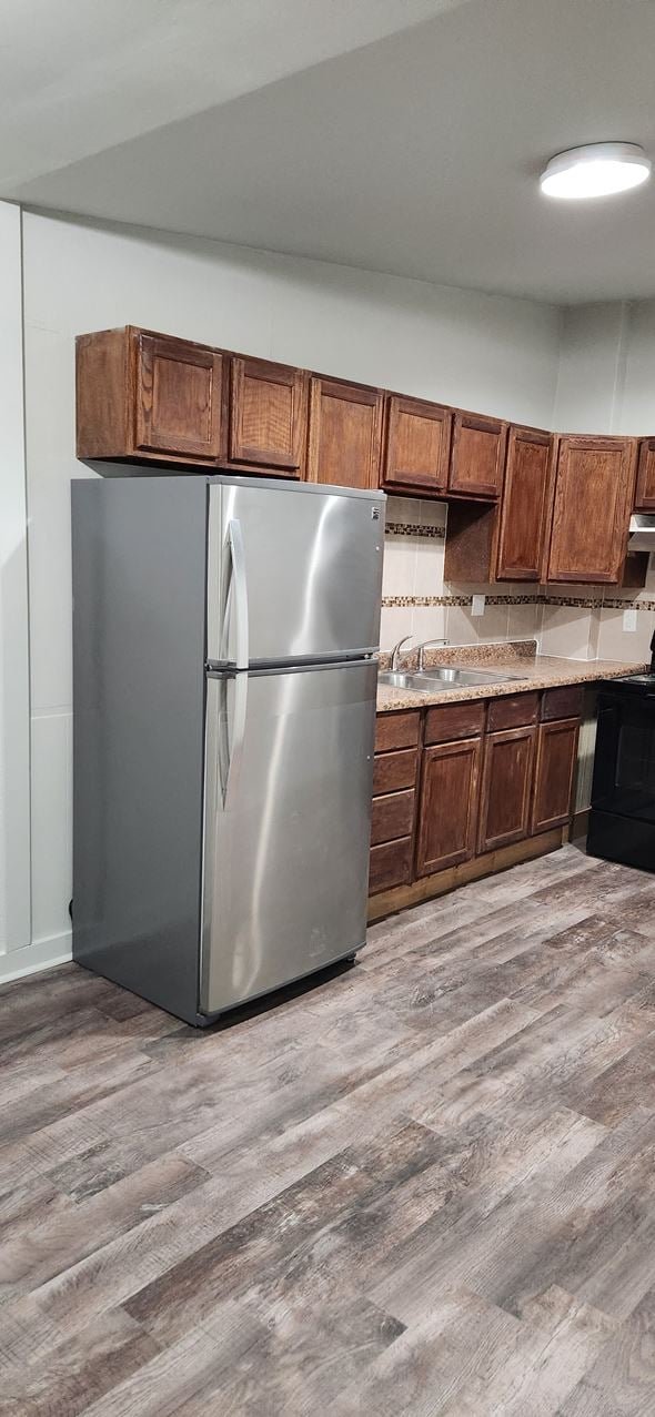 Clinton house for rent - a kitchen with a stainless steel refrigerator and wooden cabinets