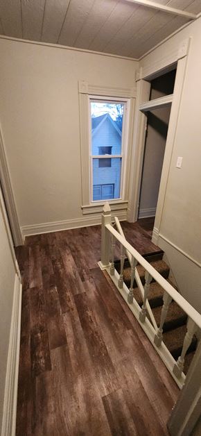 Clinton house for rent - a stairway with a window and stairs with wood floors