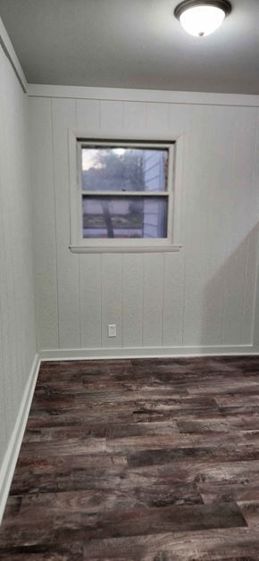 Clinton house for rent - a small room with a window and a wooden floor