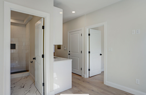 Boston apartment for rent - a kitchen with white cabinets and a white counter top and white doors