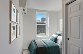 Boston apartment for rent - a small bedroom with a bed and a window