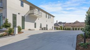 Lafayette apartment for rent - an empty street in front of a white building with a balcony
