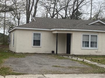 Mobile house for rent - A small house with a grey roof and white walls.