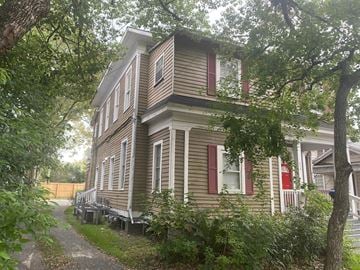Mobile house for rent - a wooden house with white shuttered windows and a sidewalk
