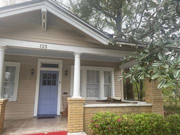 Mobile house for rent - the front of a house with a porch and a blue door