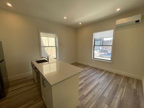 Halifax apartment for rent - an empty kitchen with a counter top and a window