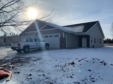Manitowoc apartment for rent - a house with a truck parked outside in the snow