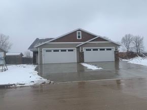 Manitowoc apartment for rent - a house with a parking lot in the snow