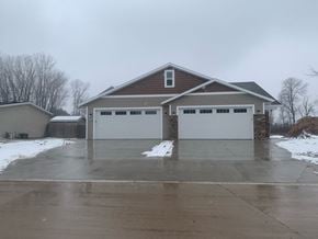 Manitowoc apartment for rent - a garage door in front of a house in the snow