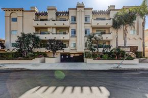 Sherman Oaks apartment for rent - a shadow of a hand on a street in front of an apartment building
