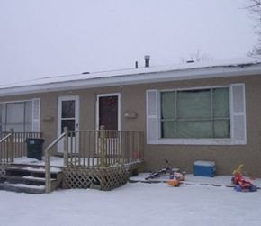 Lima apartment for rent - A house with a brown and white exterior is surrounded by snow.