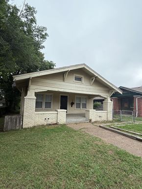 Tulsa house for rent - A small house with a grey roof and a black door.
