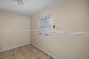 Saint Louis house for rent - an empty room with a window and a tiled floor
