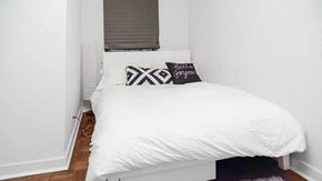 Toronto apartment for rent - a small bedroom with a white bed and a window
