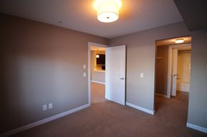 Edmonton house for rent - a bedroom with a closet and a door to a bathroom