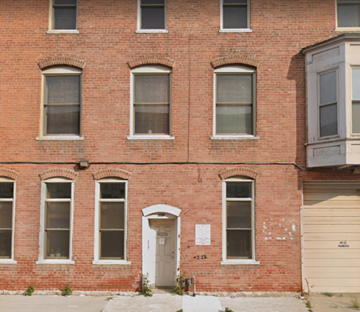 Detroit apartment for rent - the front of a brick building with a white door