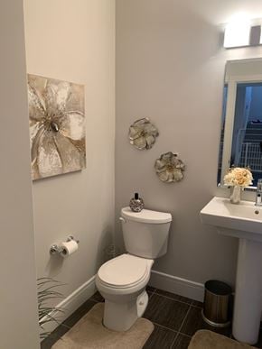 Edmonton house for rent - a bathroom with a toilet and a sink and a mirror