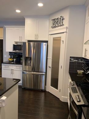 Edmonton house for rent - a kitchen with a stainless steel refrigerator and white cabinets