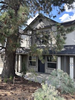 Bend apartment for rent - A house with a tree in front of it.