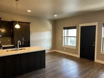 Bend apartment for rent - A kitchen with dark wood cabinets and a light-colored countertop.