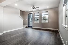 Bend apartment for rent - A room with a wooden floor and a ceiling fan.