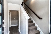 Bend apartment for rent - A staircase with a black handrail and wooden steps.