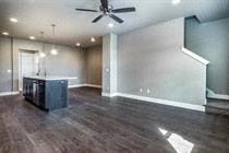 Bend apartment for rent - A spacious room with a ceiling fan and a dark brown cabinet.