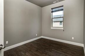 Bend apartment for rent - A room with a window and wooden flooring.