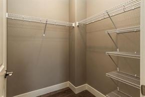 Bend apartment for rent - A walk in closet with shelves and a door.