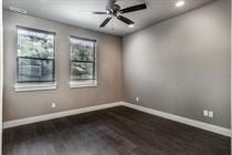Bend apartment for rent - A room with a ceiling fan and two windows.