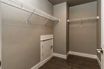 Bend apartment for rent - A walk in closet with a white door and brown carpet.
