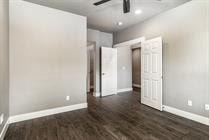Bend apartment for rent - A room with a wooden floor and a ceiling fan.